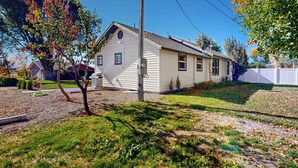 A single-story house with a sloped roof, a front garage, and a well-maintained lawn.