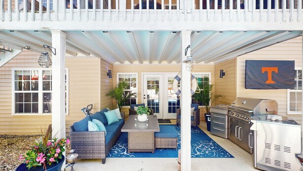 A covered outdoor patio with a dining table, sofa, and grill area. - Private Pool & Hot Tub at Luxe Ringgold Retreat (Ringgold)