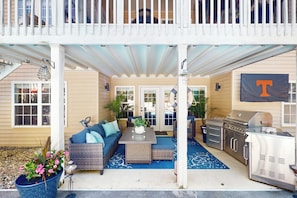 A covered outdoor patio with a dining area, seating, and a barbecue grill. - Private Pool & Hot Tub at Luxe Ringgold Retreat (Ringgold)