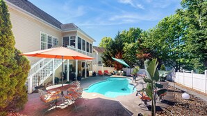 A backyard with a swimming pool, patio furniture, and a covered seating area. - Private Pool & Hot Tub at Luxe Ringgold Retreat (Ringgold)