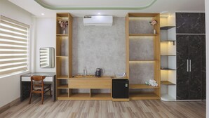 Een moderne kamer met een bureau, stoel, inbouwkasten en een zwarte marmeren kast.