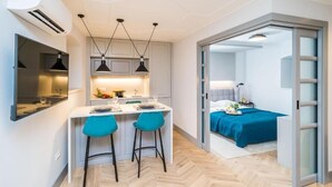 A modern room with a dining area, a bed, and a bathroom. - THE OLD WELL ELEGANCE by DuHomes  (Dubrovnik)