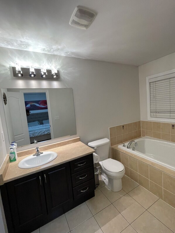 A bathroom with a sink, toilet, and bathtub.