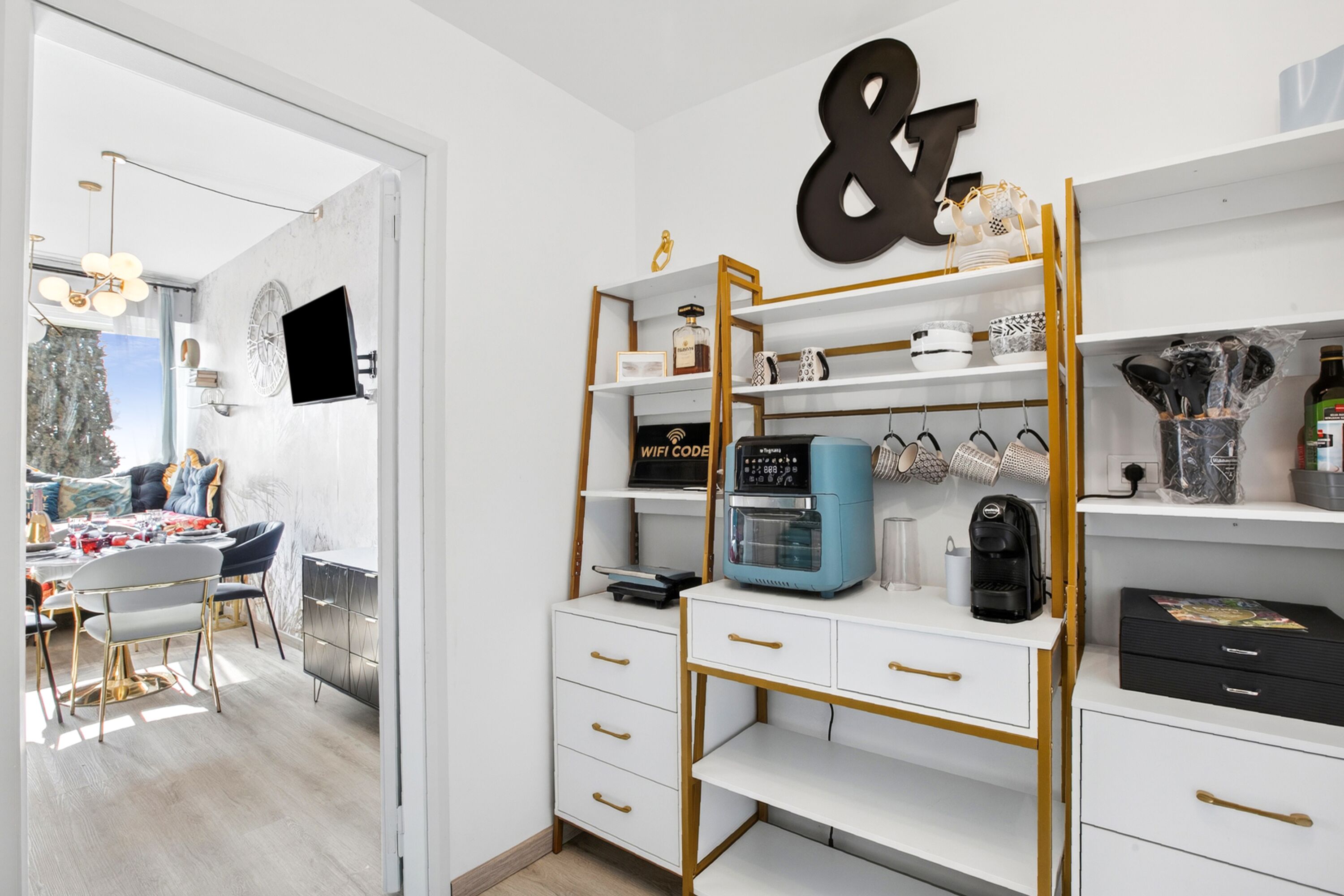 A modern room with a desk, shelves, and a large decorative letter.