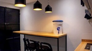 A compact kitchen with a wooden countertop, two black chairs, and a black cabinet. - *comfortable loft in the center of Quetzaltenango (Quetzaltenango)