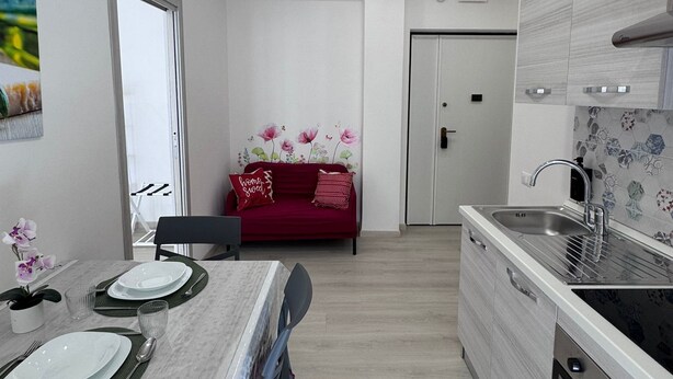 A modern kitchen with a marble countertop, a built-in oven, and a sink. - Domus Livia Vatican Cipro metro station (Roma)