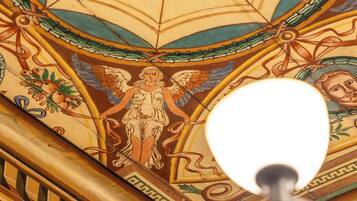 A ceiling with a geometric pattern and a central hexagonal design.