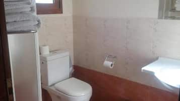 A small bathroom with a toilet, sink, and a trash can.