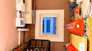 A room with a window, a heater, and a table with items on it.