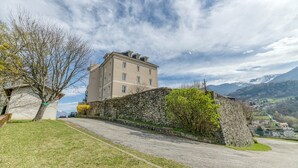 A stone wall, a building, and a road.