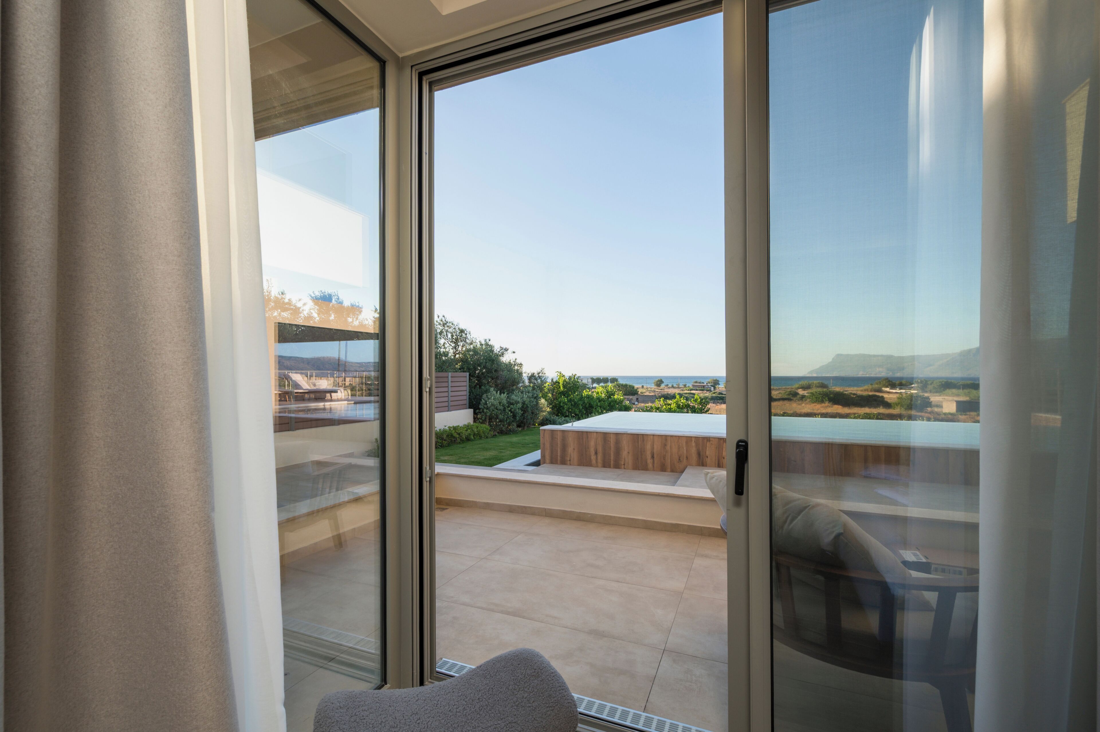 A balcony with a view of a pool and landscape.