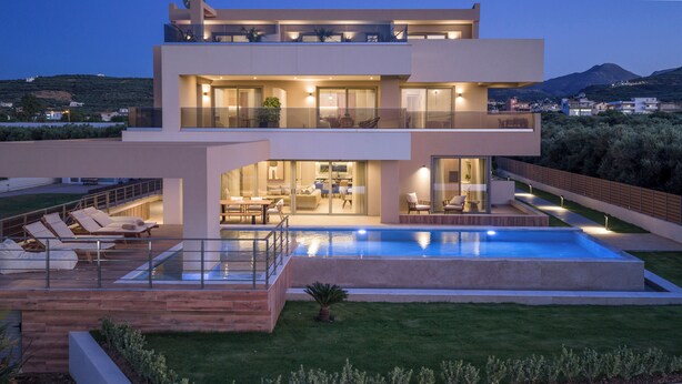 A modern two-story house with a swimming pool, outdoor seating, and a well-maintained garden. - The New Life Houses (Kissamos)