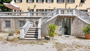 A building with a stone facade, a white staircase with balustrades, and a door leading to the entrance. - Apartment Franca in Villa Pini with Shared Pool (Sarzana)
