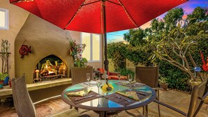 A round table with a glass top, surrounded by chairs, under a red umbrella. - Perfect For Families,Walk 2 Beach and Restaurants! (San Diego)