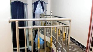 A staircase with a metal railing and a marble floor. - Exclusive Holiday Villa in Umuahia (Umuahia)