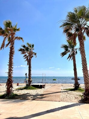 A beach with palm trees, a wooden walkway, and a clear blue sky. - Sea View-Adriatic Panorama by TOK (Durrës)