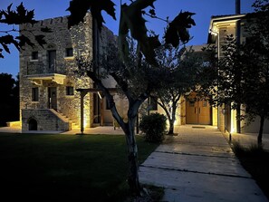 A stone building with a balcony and a wooden staircase leading to the entrance. - Villa Kalamos/Sea View and Pool nearby Athens/Superior Villa (oropos)