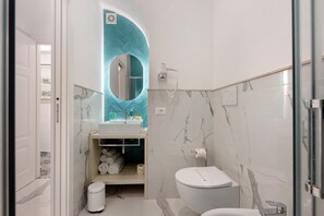 A modern bathroom with a white sink, a toilet, and a shower area. - Bed and Breakfast 'Sorrento Lux Suite' with Balcony, Wi-Fi and Air Conditioning (Sorrento)
