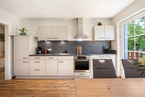 Cafetera o tetera, frigorífico, horno y placa de cocina