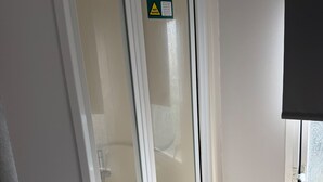A bathroom with a glass shower door, a towel rack, and a window with a view. - Beautiful 3 Bed, Sleeps 6, Wifi, Pet Friendly (Bridlington)
