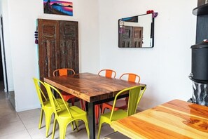 A dining area with a wooden table and four chairs, one of which is yellow.