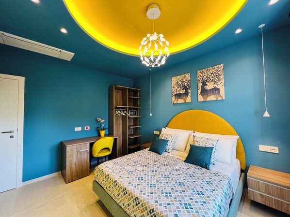 A bedroom with a bed, a desk, and a wardrobe. - YourHome - Lucrezia Suites (Sorrento)