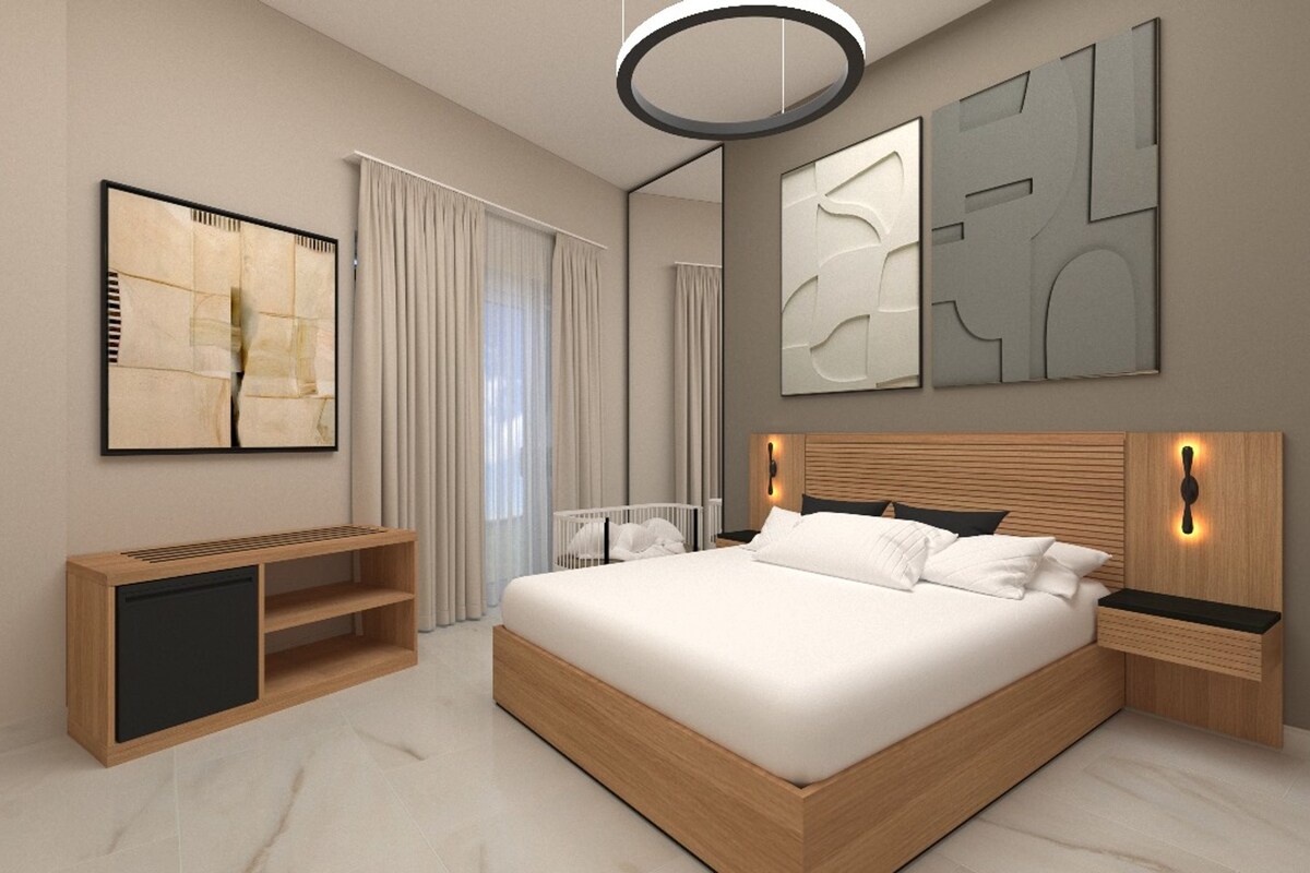 A modern bedroom with a large bed, bedside tables, a built-in TV, and abstract wall art.