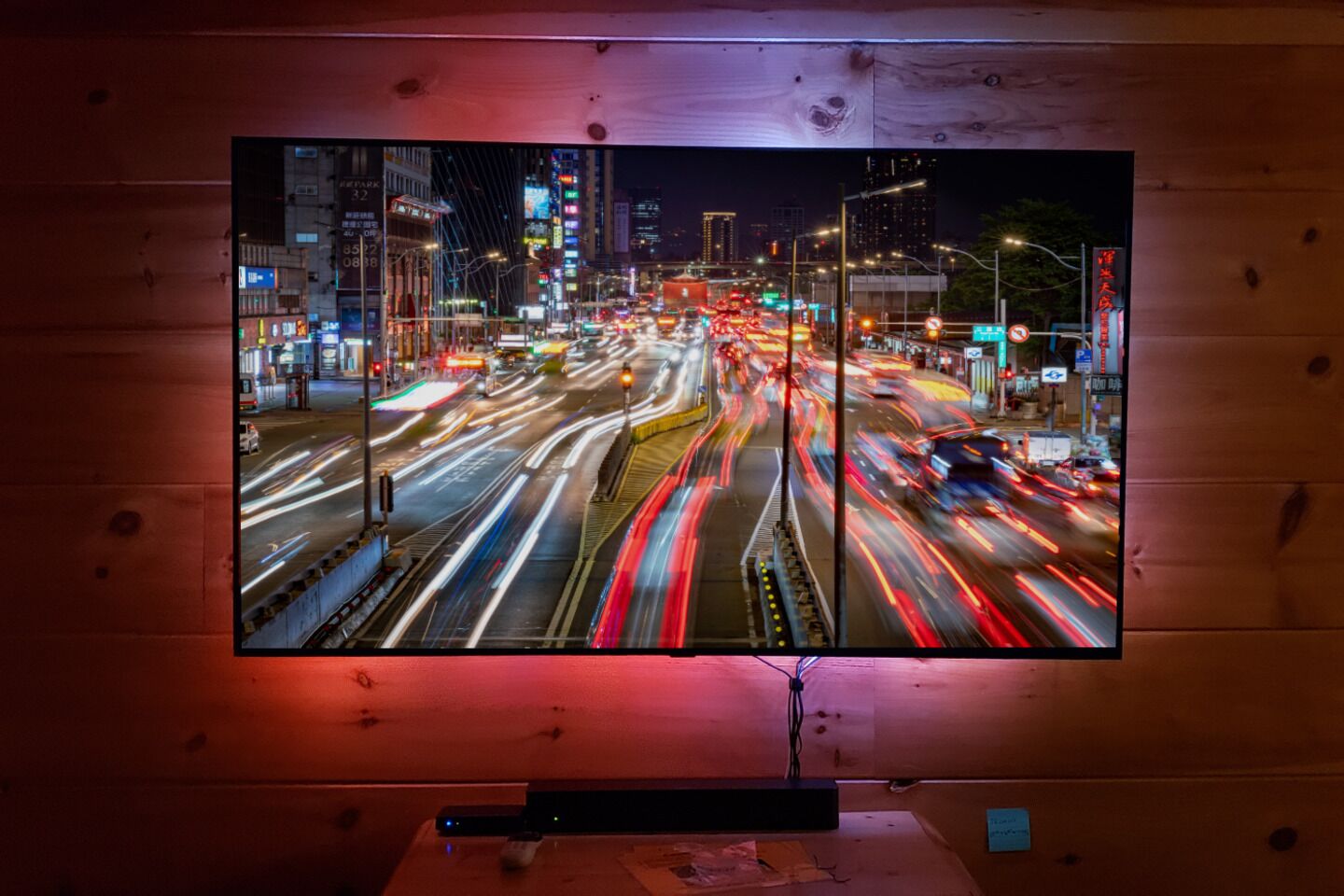 A television displaying a cityscape at night with traffic lights and street lights.