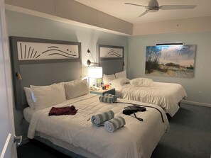 A hotel room with two beds, a ceiling fan, artwork on the walls, and a lamp on the nightstand. - OCEANFRONT 2-bedroom villa with amazing view in Marriott’s Surfwatch (Hilton Head Island)
