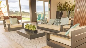 A modern living room with a sofa set, a coffee table, and a view of the outdoors. - *Modern apartment* near Antigua Guatemala (Santo Tomas Milpas Altas)