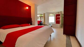 Deluxe Suite, Patio, Garden View | Desk, blackout drapes, iron/ironing board, free WiFi