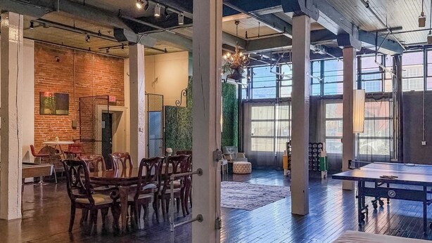 A spacious indoor area with a billiards table, wooden chairs, and a dining table set up for a meal. - Loft 40- Game Room- Sleeps 18 (Cleveland)