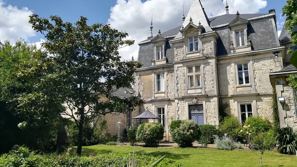 A large stone building with multiple windows and a prominent tower. - THE LARGE COTTAGE AT CHÂTEAU SAINTE MARIE NEAR THE MARAIS POITEVIN (Fors)