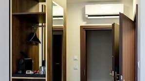 A hallway with a wooden wardrobe, a mirror, and a door leading to another room. - Sleep&Fly Okecie (Warsaw)
