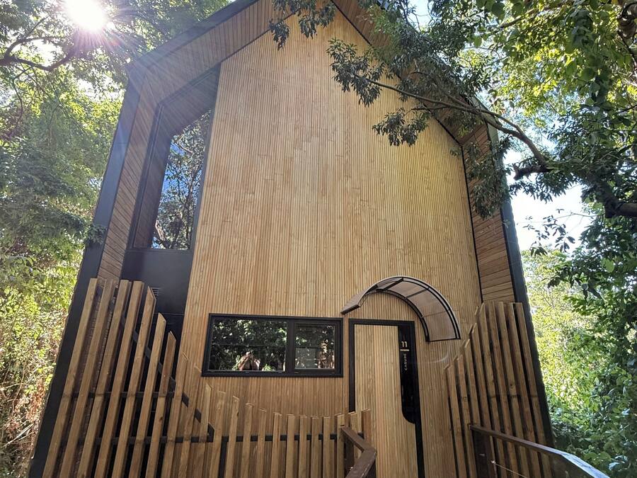 A wooden structure with a staircase leading to a door marked '11'.