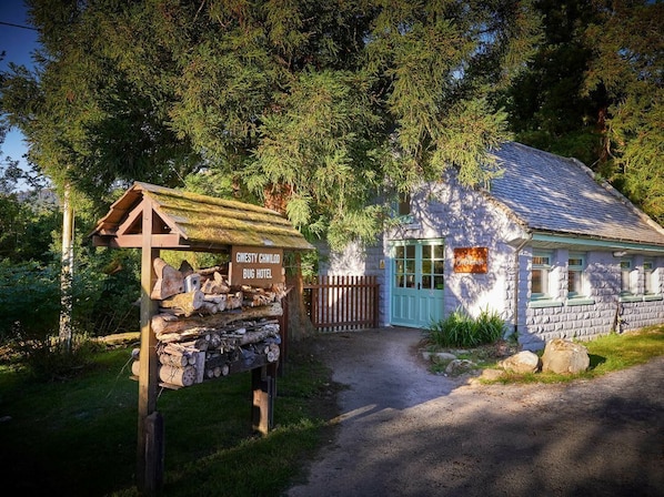 Ein rustikales Blockhaus-Hotel mit hölzernem Schild, einer Steinfassade und einladendem Eingang.