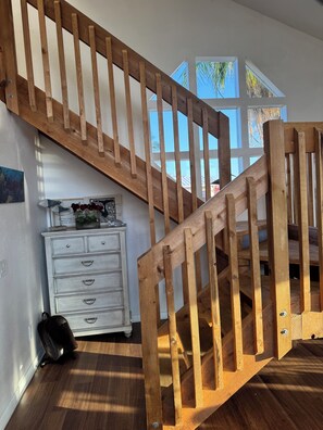 A wooden staircase with a white dresser and a black bag on the floor. - Monthly rental  lap pool 40 ft dock wDavitz (Big Pine Key)