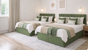 A bedroom with two green upholstered beds, white bedding, and two bedside lamps. - Stylist 7sleeps contractor groups friendly1bedroom flat Canada Water free WiFi (London)