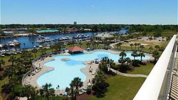 A resort with a large central pool, a marina with boats, and a view of the surrounding landscape. - Cypress Bend @ Barefoot - Updated w/ Pools, Golf, Shuttle (North Myrtle Beach)