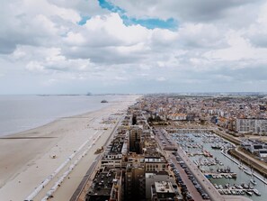 A coastal cityscape with a beach, marina, and dense urban area. - Centrally located by Interhome (Blankenberge)