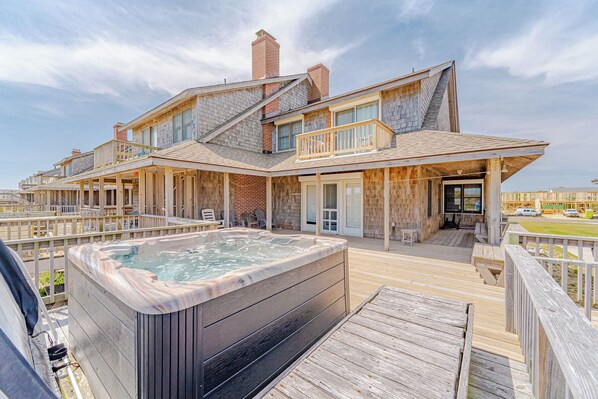 A two-story house with a hot tub on the deck, wooden railings, and a view of the ocean. - JL#201 | SIX - Classic Nags Head Oceanfront home with Hot Tub (Nags Head)