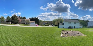 A residential area with houses, a grassy lawn, and a clear sky.