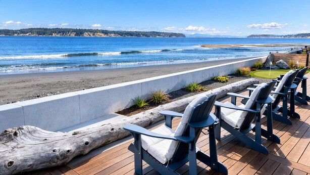 A deck with chairs overlooking a beach and ocean. - Beachfront I Tiki lounge | Pool table | Pinball I Mini Golf (Langley)