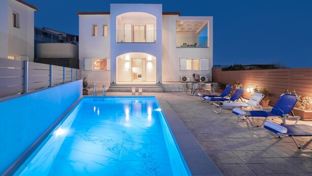 A modern two-story building with a swimming pool and outdoor seating area. - Villa Ocean Pool in Planos (Zakynthos)