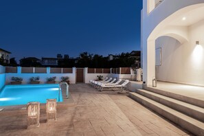 A pool area with lounge chairs and a staircase leading to an upper level. - Villa Coral Blue in Planos (Zakynthos)