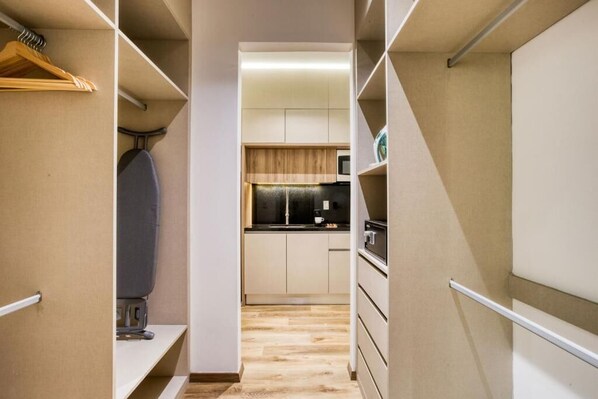 A narrow hallway with a kitchen at the end.