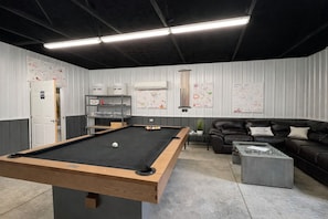 A billiards room with a pool table, a sofa, and a coffee table. - The Hummingbird Yurt: Unique Hocking Hills Stay w/ Hot Tub, Fire Pit + Game Barn (Logan)