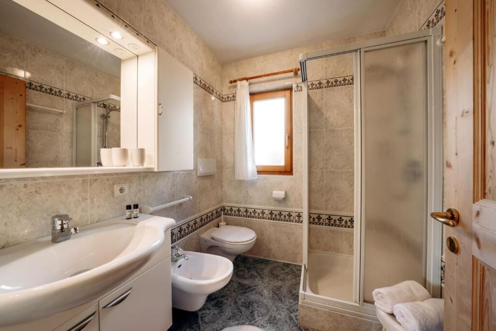 Ein Badezimmer mit Waschbecken, Bidet, Toilette und Dusche.