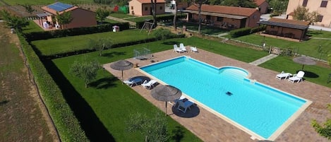 Alberca al aire libre por temporada y sombrillas en la alberca