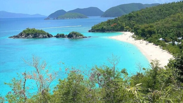 A coastal landscape with a beach, clear turquoise waters, and lush greenery. - Little Cay – A Sweet Family Escape Ocean View (Cruz Bay)